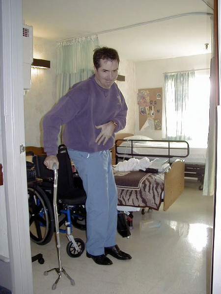 Tom rising from his wheelchair.